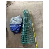 Green safety barrier fence and tarp