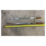 2 brass wood handled swords