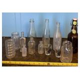Glass jars, bottles and shot glasses.