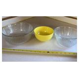 Two Pyrex mixing bowls and yellow plastic bowl.