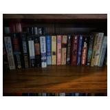 Two rows of book on shelf including Stephen King