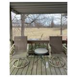 Two swivel patio chairs with some tears in seats
