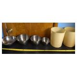 Aluminum bowls and tall plastic containers.