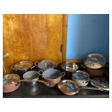 Green Pan brand pans, some with lids.