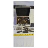screwdriver bits and a metal tool case nut