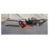 Two electric hedge trimmers