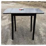 Black wooden folding table with a drop leaf