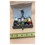 Sewing kit in a green textured case.