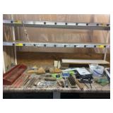 Brooms and everything on top of countertop.