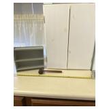 White cabinet, gray shelf and a wooden gavel.