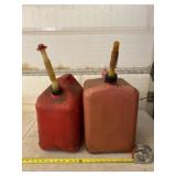 Two five gallon gasoline jugs.