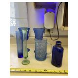 Blue vase, glasses and pitcher with green vase.