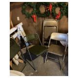 Two green padded chairs and four padded fold up