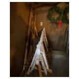 Two wood saw horses and all wood in corner.