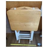 Four folding tv trays with stand.