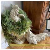 Two resin roosters with greenery and resin base