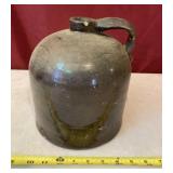 Brown stoneware jug with chip on top.