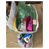 Tote with lid full of gift bags, ribbons and