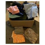 Box of material and tablecloths.