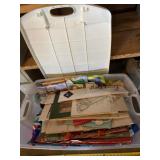 Tote with lid full of reusable bags, gift bags