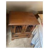 Wooden end table with two doors in a drawer