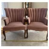Two pink velvet channel back armchairs.