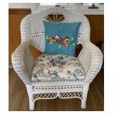 Wicker chair with cushion and pillow .
