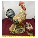 Tall resin rooster with smaller ceramic rooster.