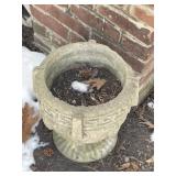 Two concrete planters, other one under the snow