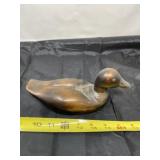 Wood carved duck with glass eyes.
