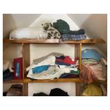 Contents on shelf towels, clothes, blankets