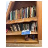 Books on shelf, including murder by yard, pluck