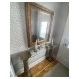 Glass table with pedestals, mirror and decor on