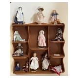 Porcelain doll collection with sand and wall
