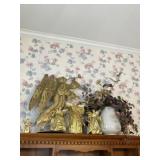 Angels, pottery vase and artificial flowers.