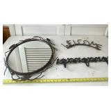 Mirror, Welcome sign and hanging coat rack.