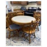 Ashley round tile top table with four chairs. One