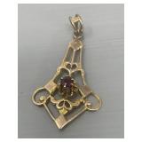 10 karat gold pendant with garnet stone .78g