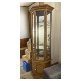 Lighted corner curio cabinet 69 inches tall.