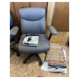 Office chair, printer paper and rugs.