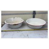 2-white enamel wash basins with red rims.