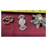 Brooches including MONET
