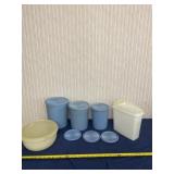 Tupperware containers with lids and extra lids.