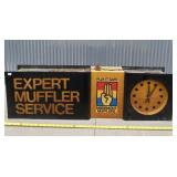 Hanging Maremont Mufflers sign and clock.