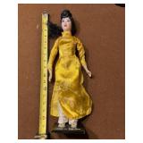 Vietnamese souvenir doll is dressed in a yellow