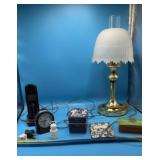 Hurricane-style table lamp featuring a brass base