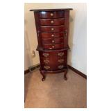Cherry wood jewelry armoire featuring brass