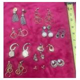 11 pairs of silver and gold tone earrings