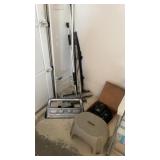 Brooms flag two umbrellas, a stepstool mounting