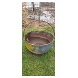 Old cast iron kettle has a hole in it